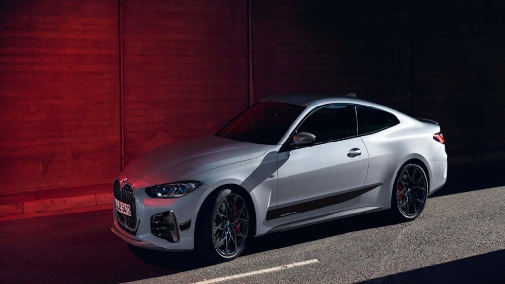 Silver BMW M4 parked with dark red lighting showcasing sporty aggressive M Series design wallpaper