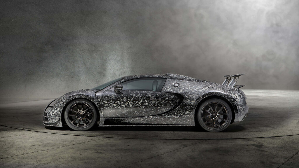 Silver Bugatti Veyron C7 parked in dim room with dramatic shadows and textured concrete floor wallpaper