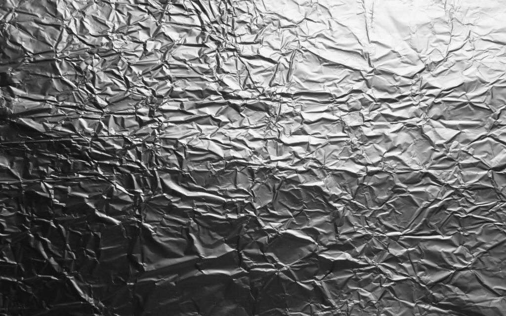 Reflective silver foil texture wallpaper with crinkled metallic effect high contrast QHD background
