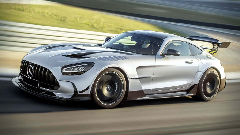White silver Mercedes GTS speeding on racetrack showing sleek design sporty curves and aerodynamics Wallpaper