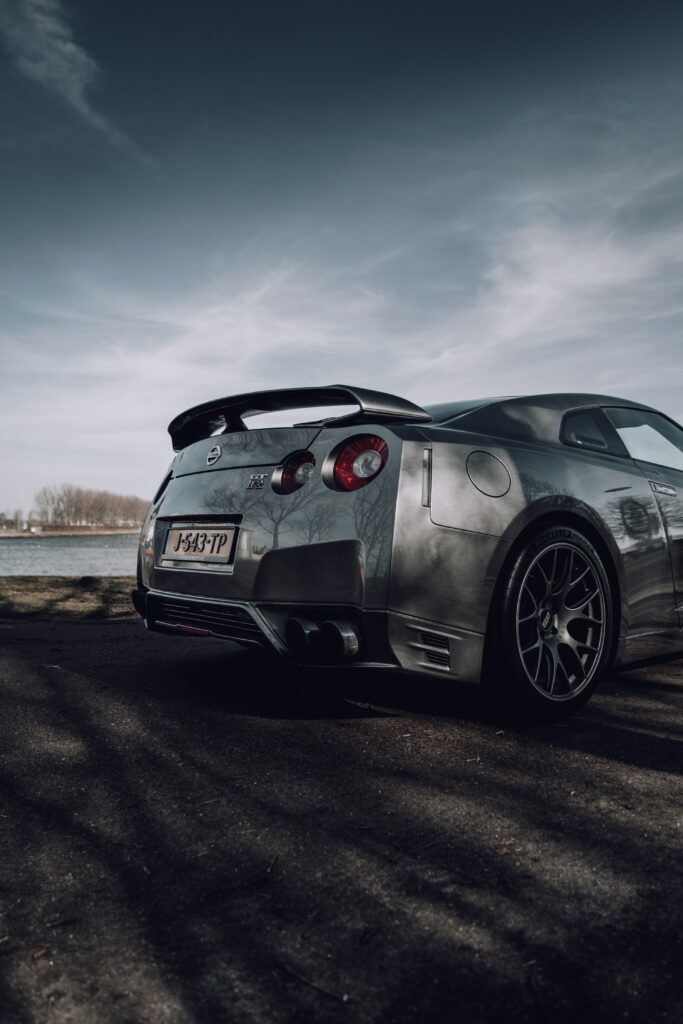 Sleek Silver Nissan GT-R Side View Wallpaper with Moody Sky Background