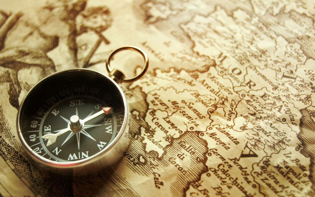 Vintage Exploration: Nostalgic Adventure with a Silver Pocket Compass on an Old Morea Map Wallpaper