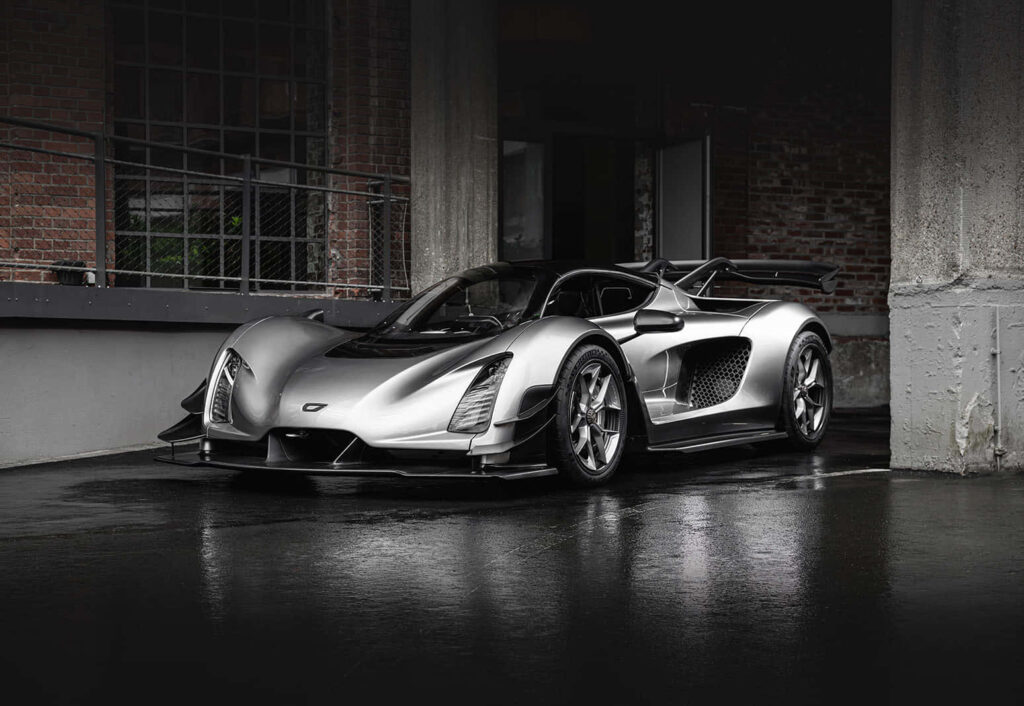 Silver supercar with aerodynamic design under urban overpass ready for race track wallpaper