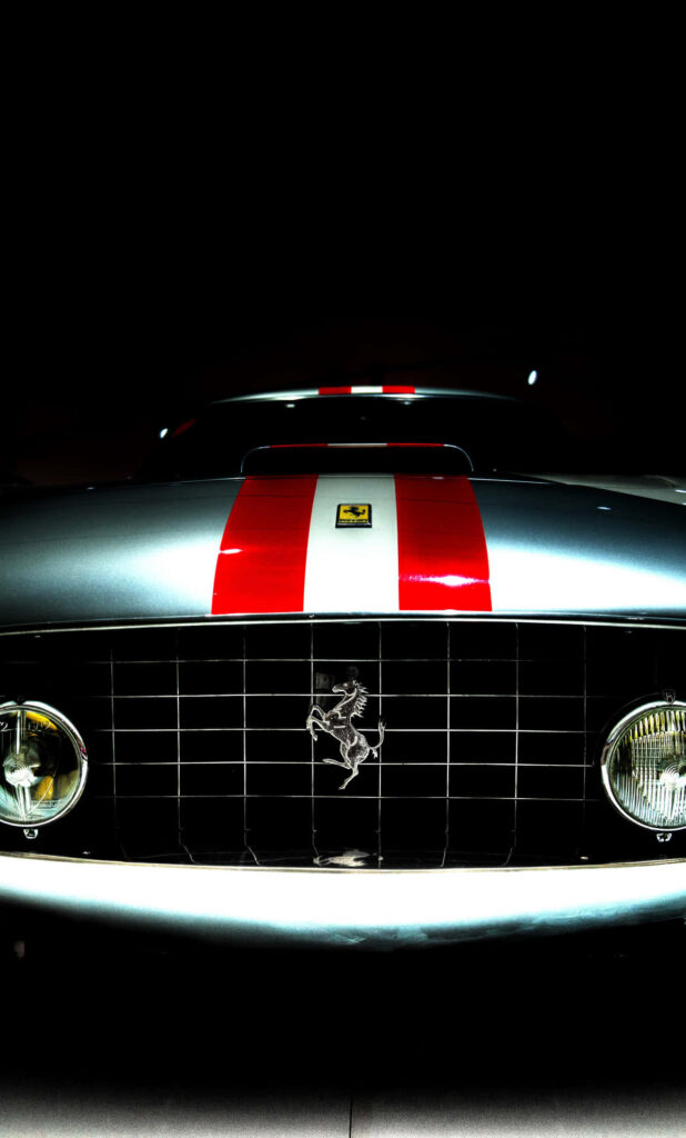 Silver Vintage Ferrari 250 GTO front view with bold red racing stripes on dark background wallpaper