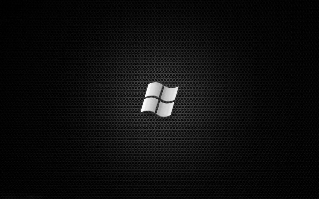 Sleek Silver Windows Logo Shines on Stunning Textured Black Desktop Wallpaper
