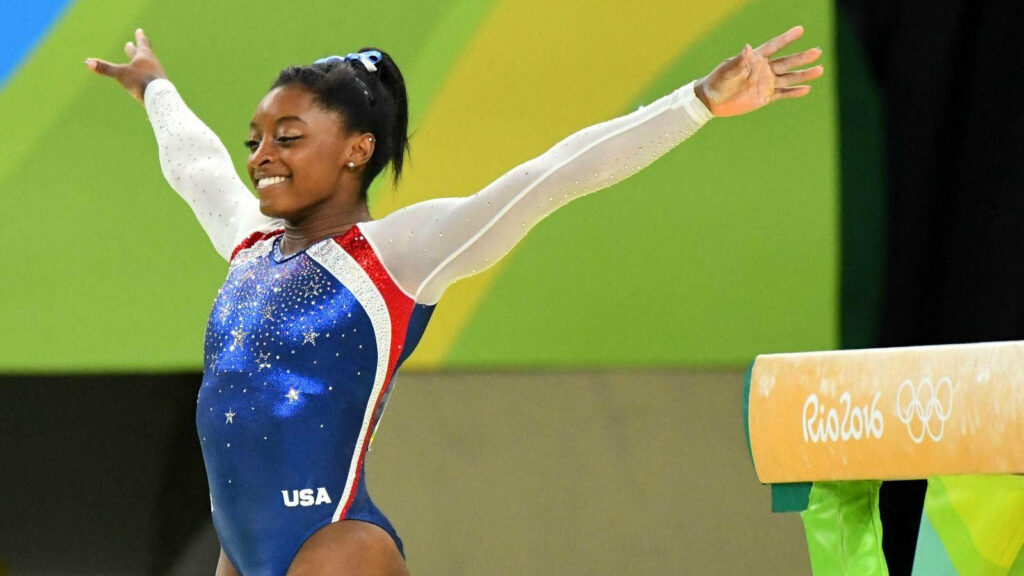 Simone Biles Triumph: Captivating Olympic Performance Wallpaper