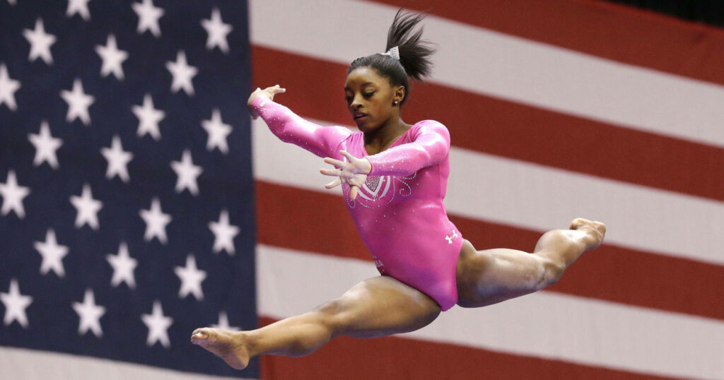 Simone Biles Split Jump Wallpaper: Grace & Strength in Pink