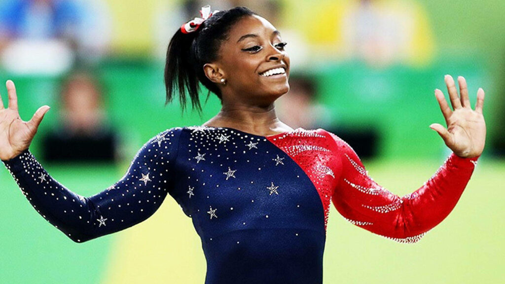 Simone Biles Shines in Blue & Red Starry Costume - Wallpaper Background