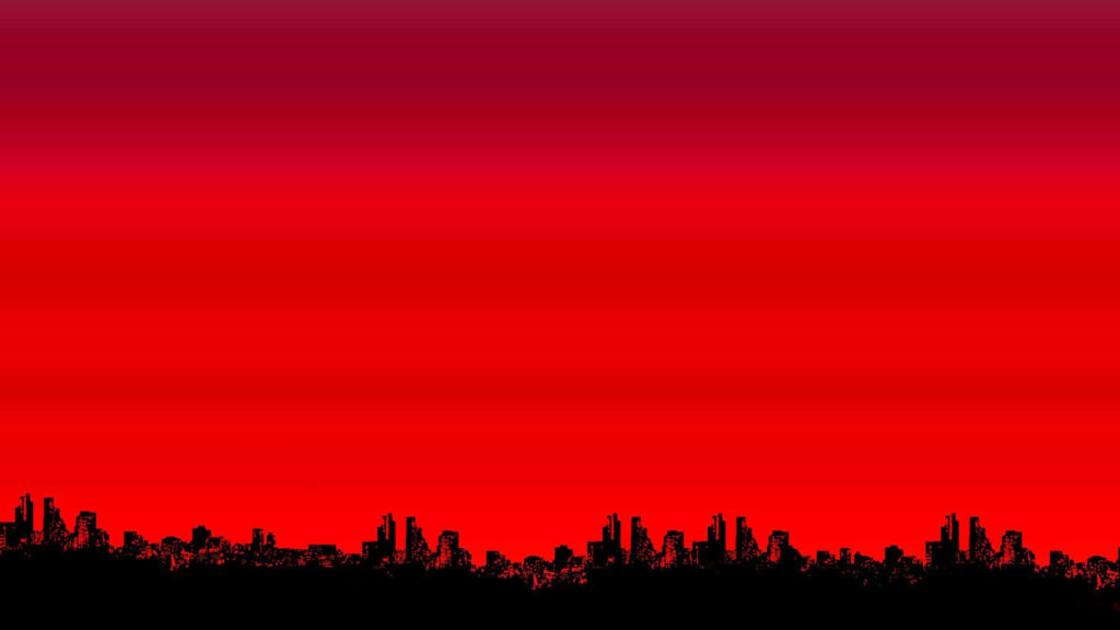 Crimson Horizon: A Red Aesthetic Laptop Wallpaper Featuring Silhouetted Buildings Against a Vibrant Sky