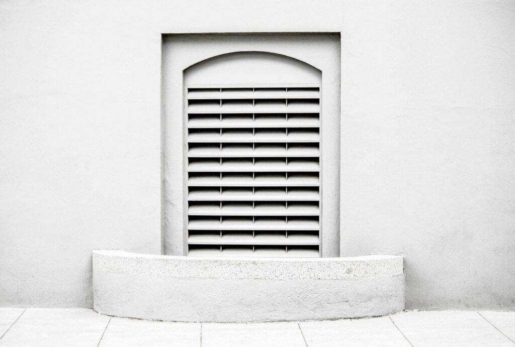 Subtle Simplicity: Embracing Minimalism with a Small White Door in a Pristine Home Wallpaper
