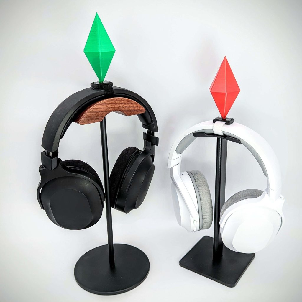 Gaming accessories wallpaper with Sims green and red Plumbobs on headphone stands minimalist setup