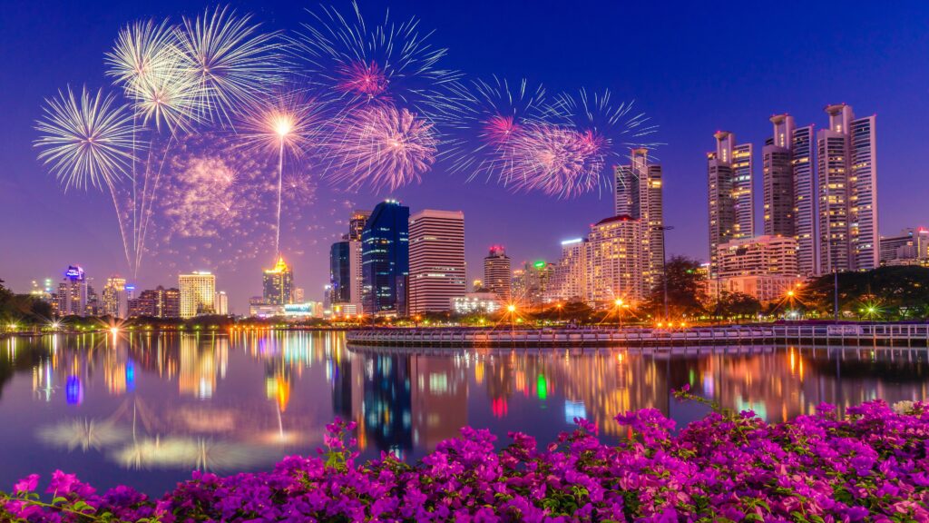 Sparkling Nights in Singapore: A 4K Ultra HD Fireworks Wallpaper with Skyscrapers and Reflections