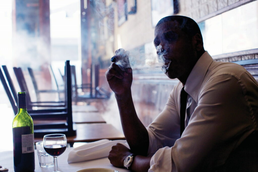 Mysterious Gangster in Dimly Lit Restaurant Wallpaper for Business