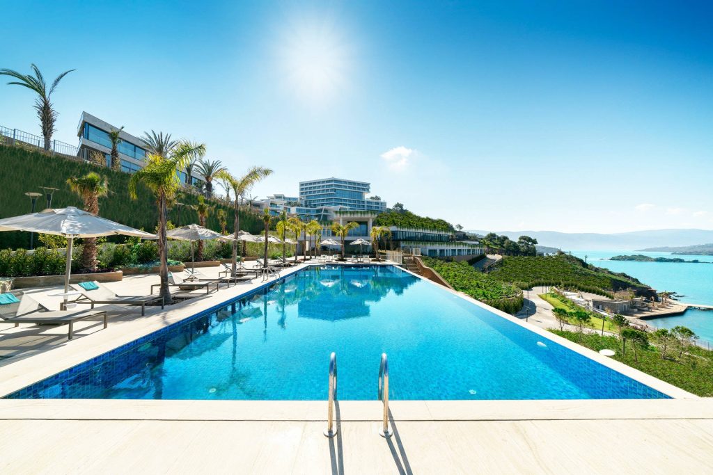 Six Senses Kaplankaya infinity pool with palm trees modern design Mediterranean sea view wallpaper