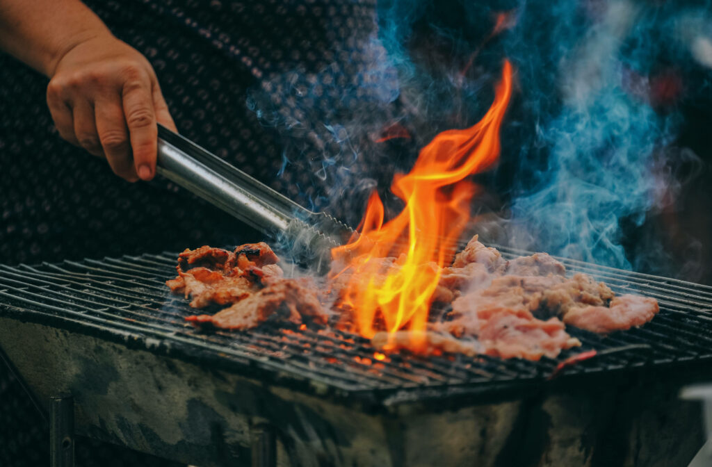 Flaming Churrasco Delight: Sizzling Meat Grilled to Perfection Wallpaper