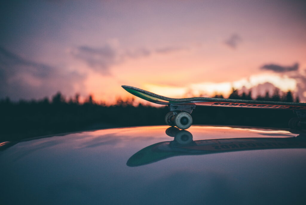 Spectacular Skateboarding Sunset: A Graphy of Thrilling Moves and Vibrant Background Wallpaper