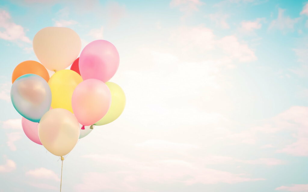 Vibrant Balloons Floating Amidst the Dreamy Sky: A Captivating QHD Wallpaper