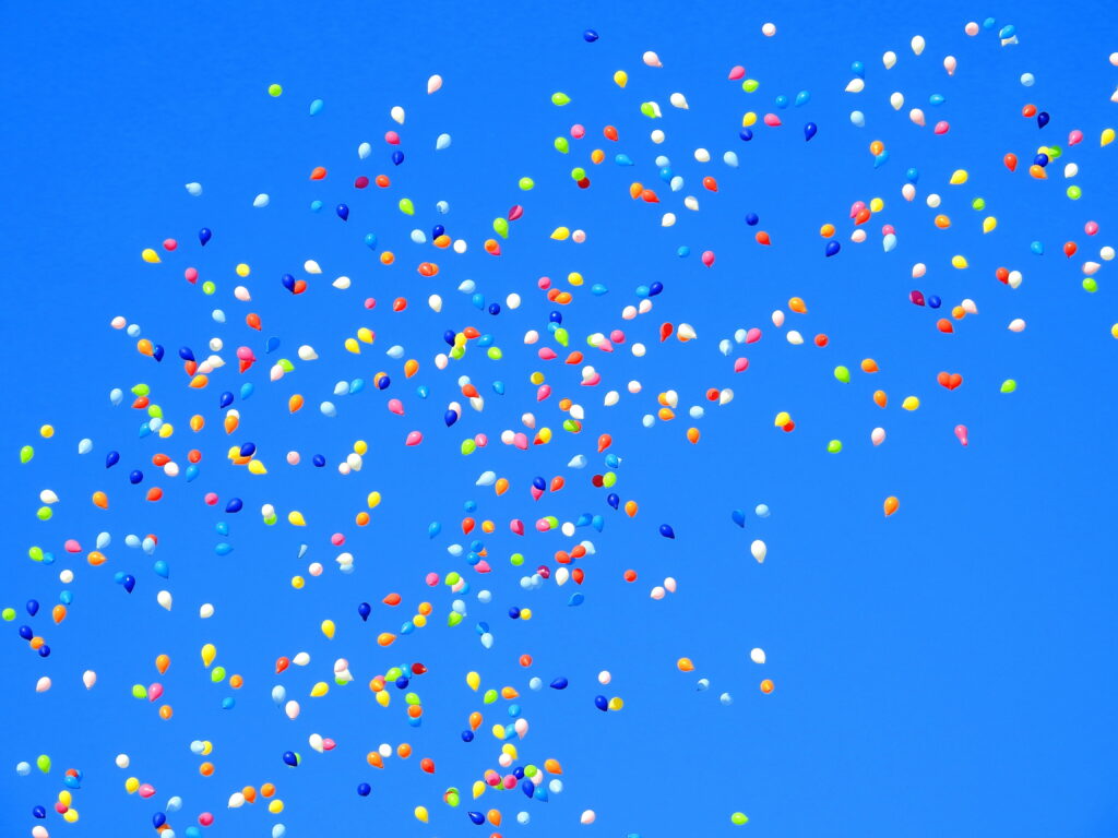 Carnival Birthday Bash: Colorful Balloons Beneath a Blue Sky HD Wallpaper