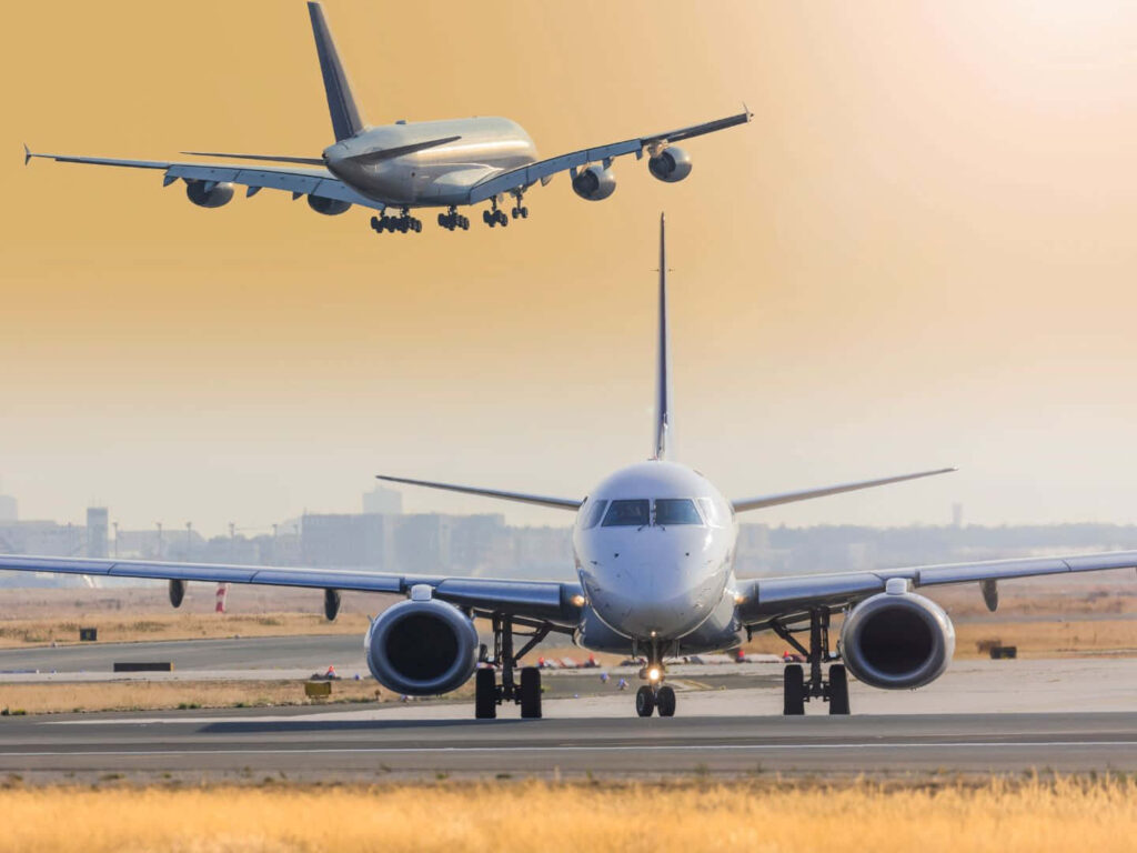 High-flying Spectacle: Mesmerizing 1440p Backdrop Showcasing a Aircraft on Tarmac with Soaring Jet in the Distance Wallpaper