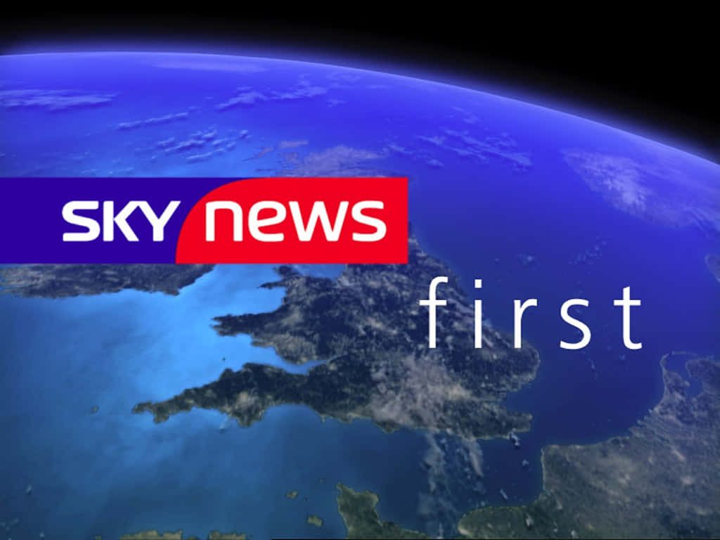 Sky News First logo over CGI satellite view of UK and English Channel broadcast wallpaper background