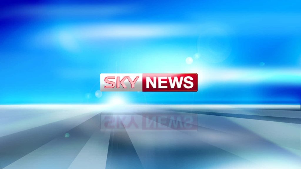 Sky News wallpaper with red white logo on blue digital background and radiant light rays design