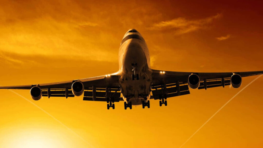 Skybound Giants: Majestic jumbo jet soars above, captivating with its immense size and stunning livery design Wallpaper