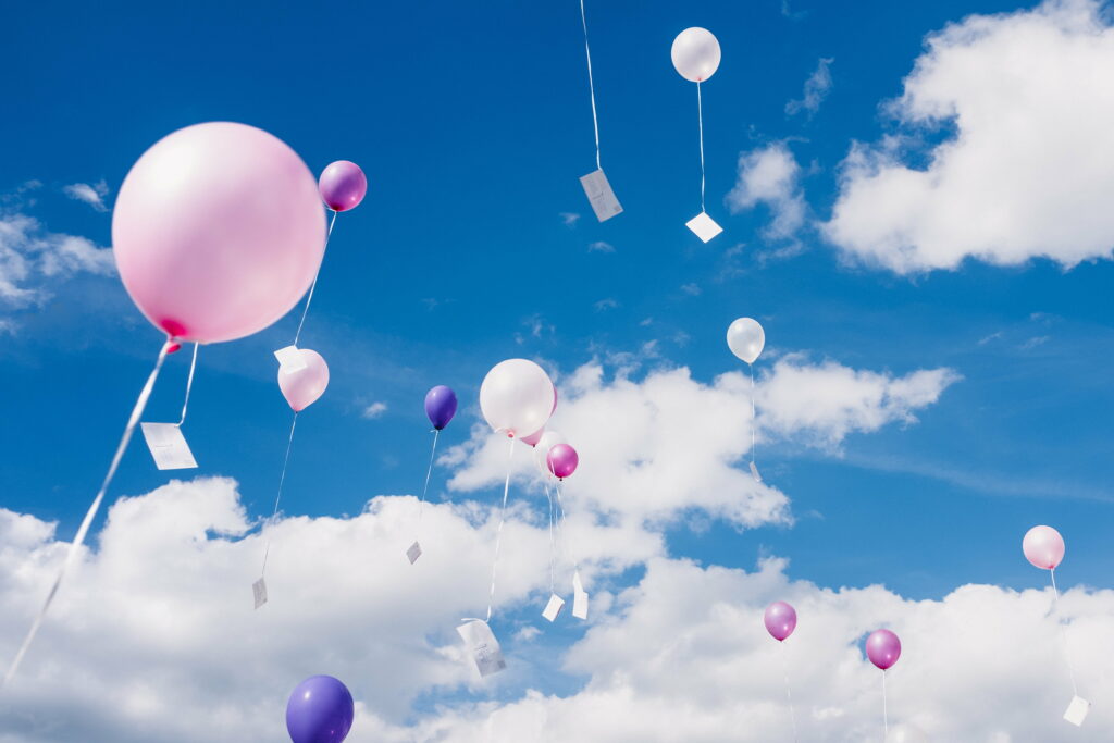 Experiencing the Freedom of Elevated Skies: A Captivating 4K Wallpaper with Colorful Balloons Soaring Amidst the Clouds