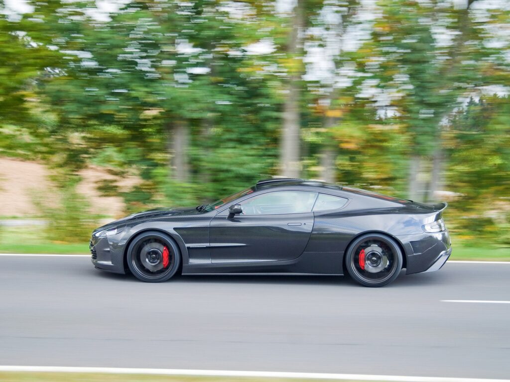 Dynamic Side View: 2004 Aston Martin DB9 Wallpaper on Asphalt