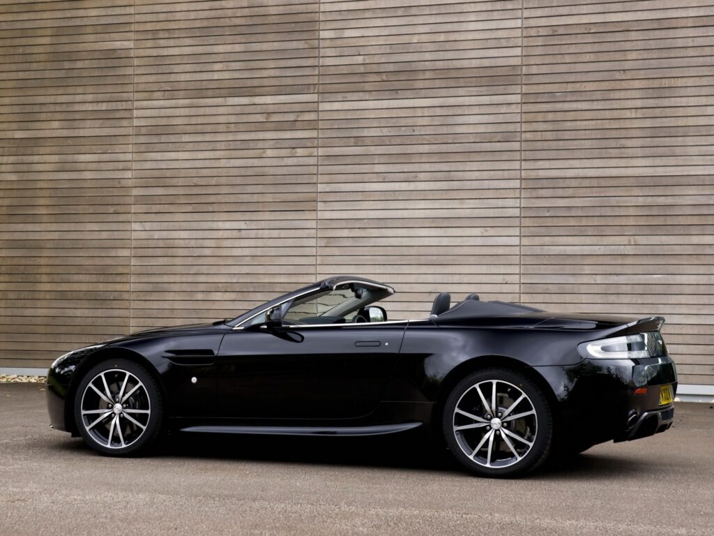 Sleek Black 2010 Aston Martin V8 Vantage Side View Wallpaper
