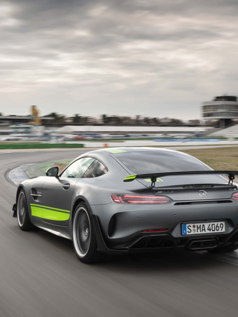 AMG GT-R with green accents racing on track dynamic wallpaper for Android devices background