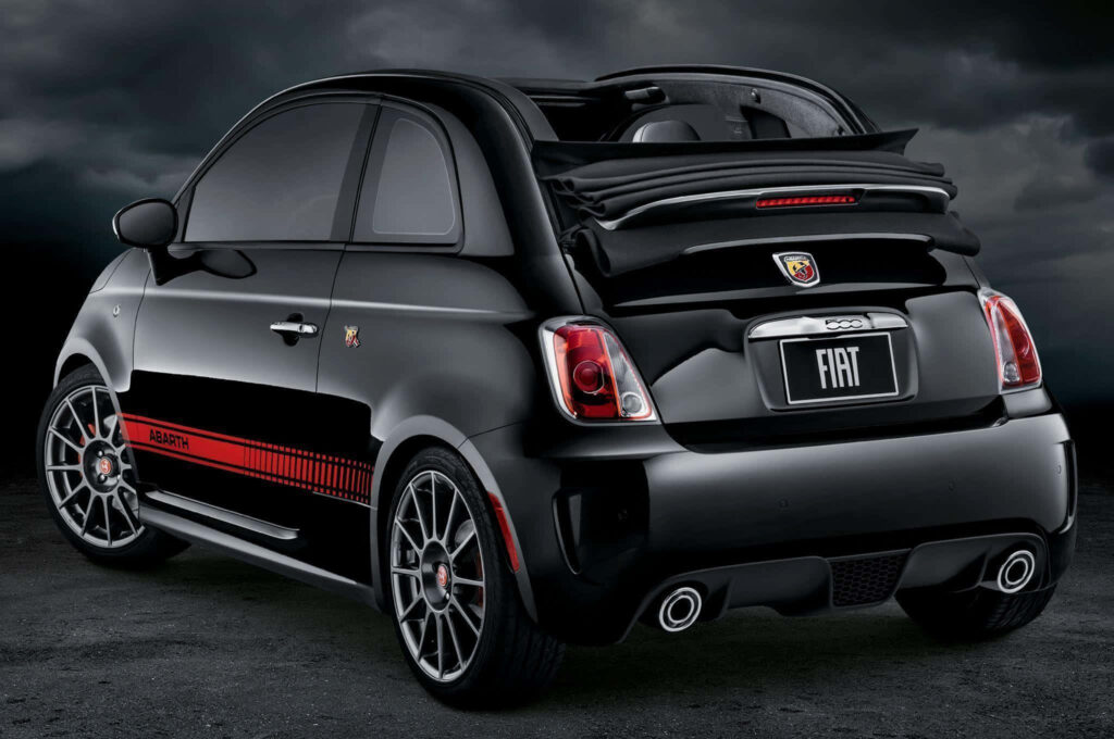Sleek Abarth sports car with bold red accents against dramatic backdrop wallpaper background