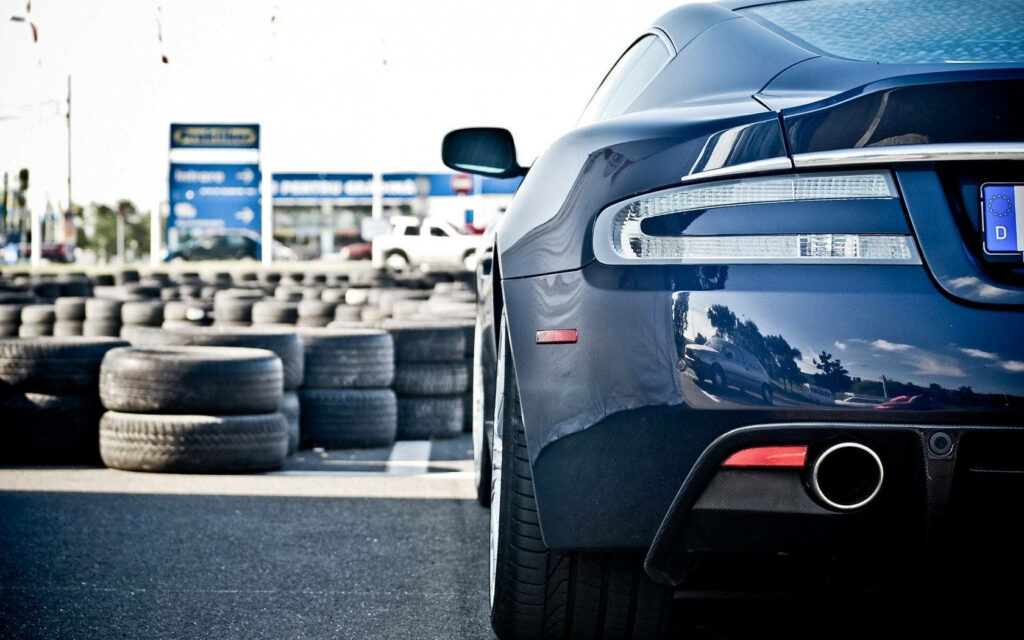 Sleek Aston Martin Race Car Rear View: Elegant Design & Performance Wallpaper