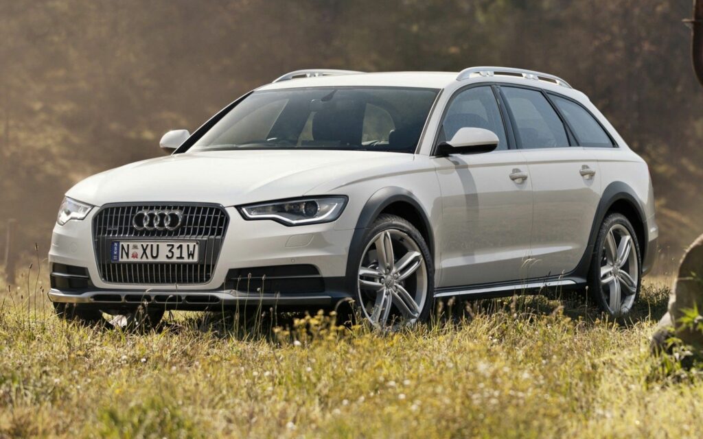 Stunning Audi A6 Allroad: High-Res Front View on Grassy Terrain Wallpaper