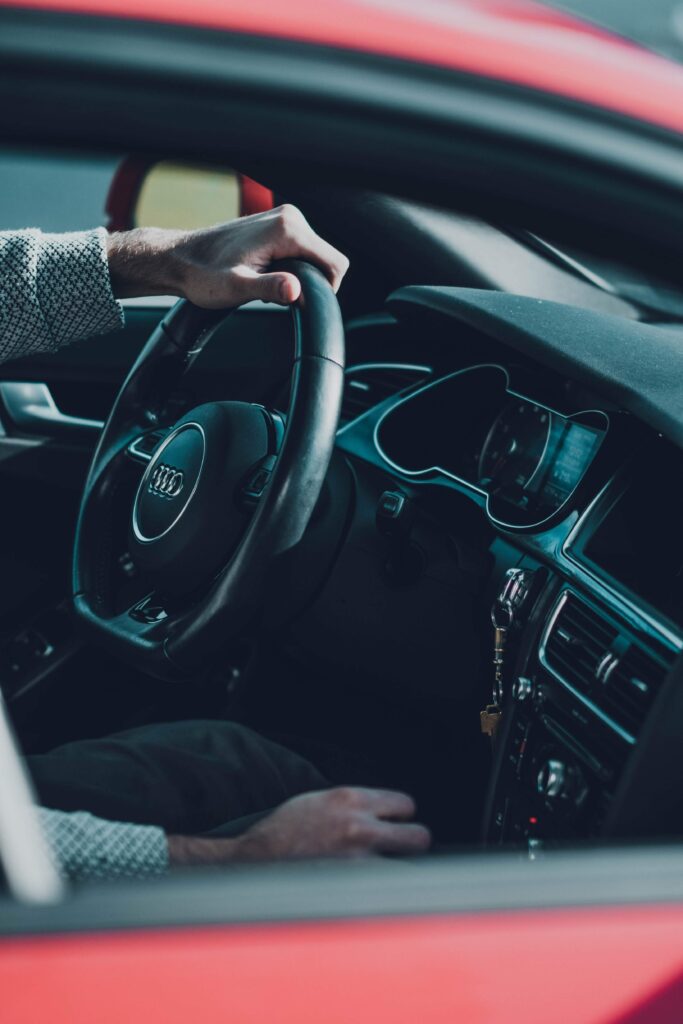 Luxury Audi Interior: Driver's Hands on Steering Wheel Elegance Wallpaper