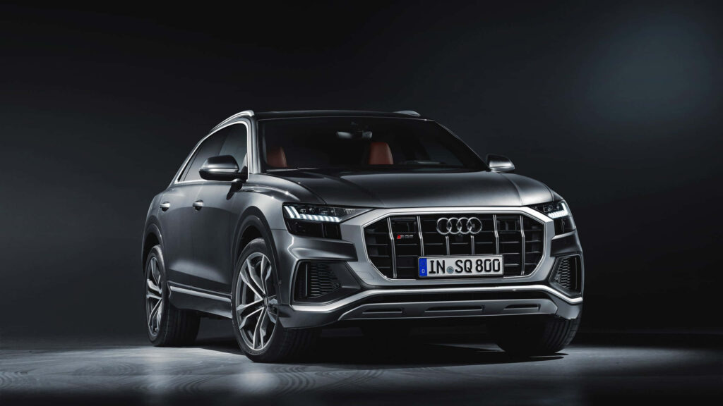 Sleek Audi sports car under dramatic lighting showcasing modern design and powerful presence Wallpaper