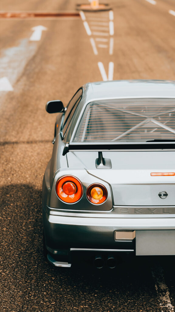 Autech GTR Wallpaper: Sleek Design & Polished Taillights on Open Road