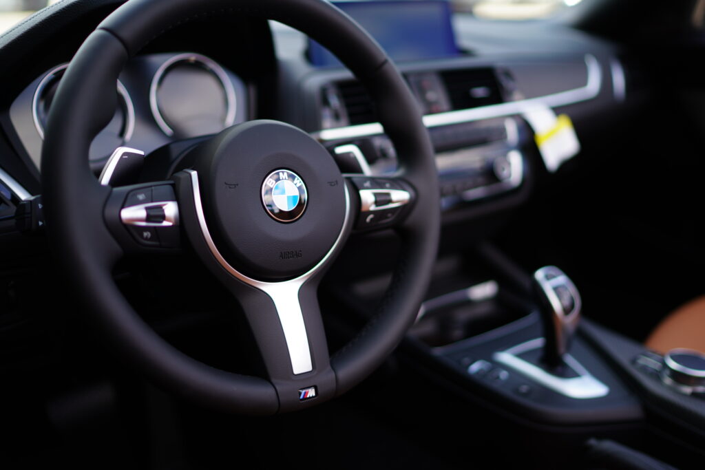 Luxurious BMW Interior Wallpaper: Focus on Sleek Steering Wheel Design