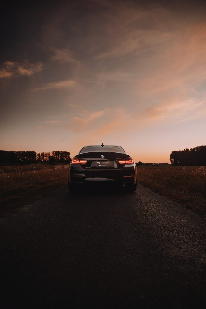 Sporty BMW M4 Rear View at Sunset - Dynamic Wallpaper Background