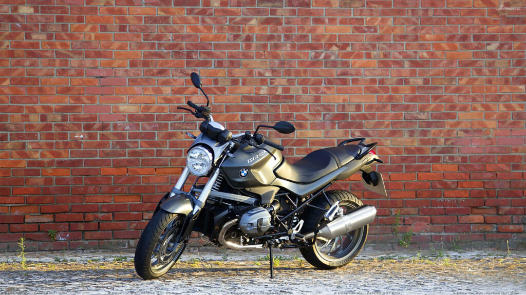 Stylish BMW R1200R Wallpaper: Black Bike Against Rustic Brick Wall