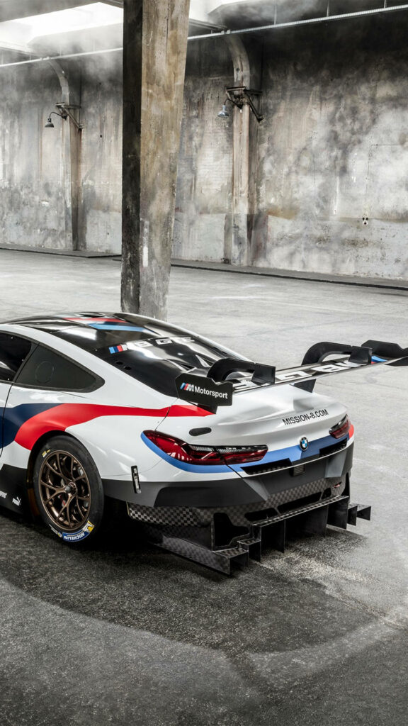 Sleek BMW Race Car in Gritty Garage - Dynamic Wallpaper for Galaxy S4