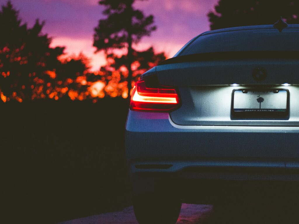 Sleek BMW Rear View at Sunset: Elegant Design & Illuminated Taillights Wallpaper