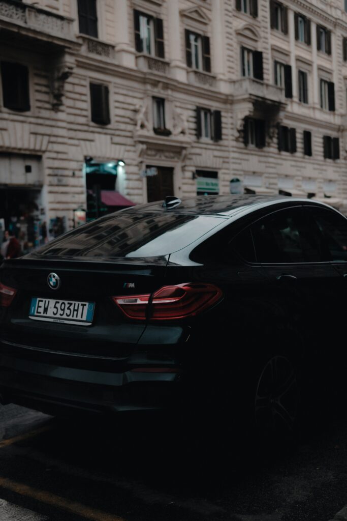 Stylish Black BMW Rear View in Historic Urban Setting Wallpaper
