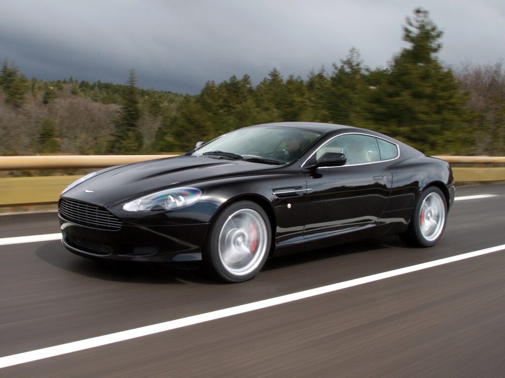 Sleek Black 2006 Aston Martin DB9 on Vibrant Asphalt Road Wallpaper