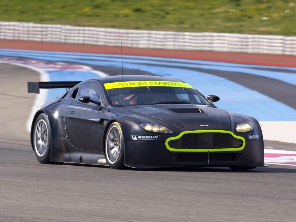 Sleek Black 2008 Aston Martin V8 Vantage on Racetrack Wallpaper