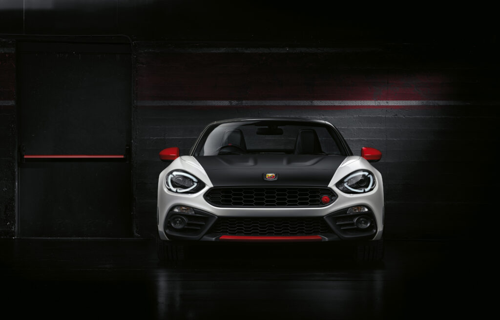 Sporty Black Abarth Fiat Wallpaper: Bold Design on Dark Background