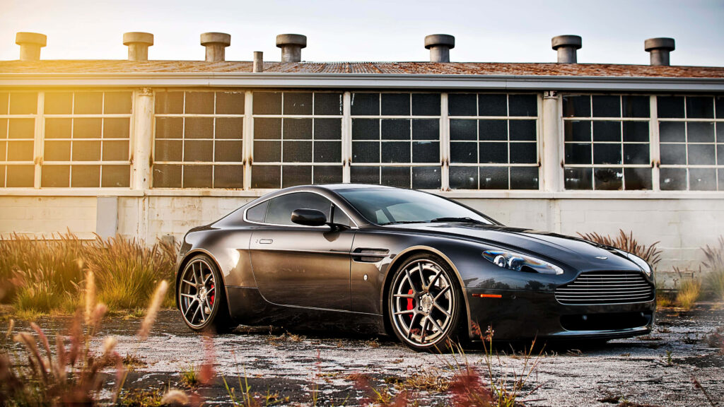Sleek Black Aston Martin Wallpaper: Luxury Meets Urban Ruggedness