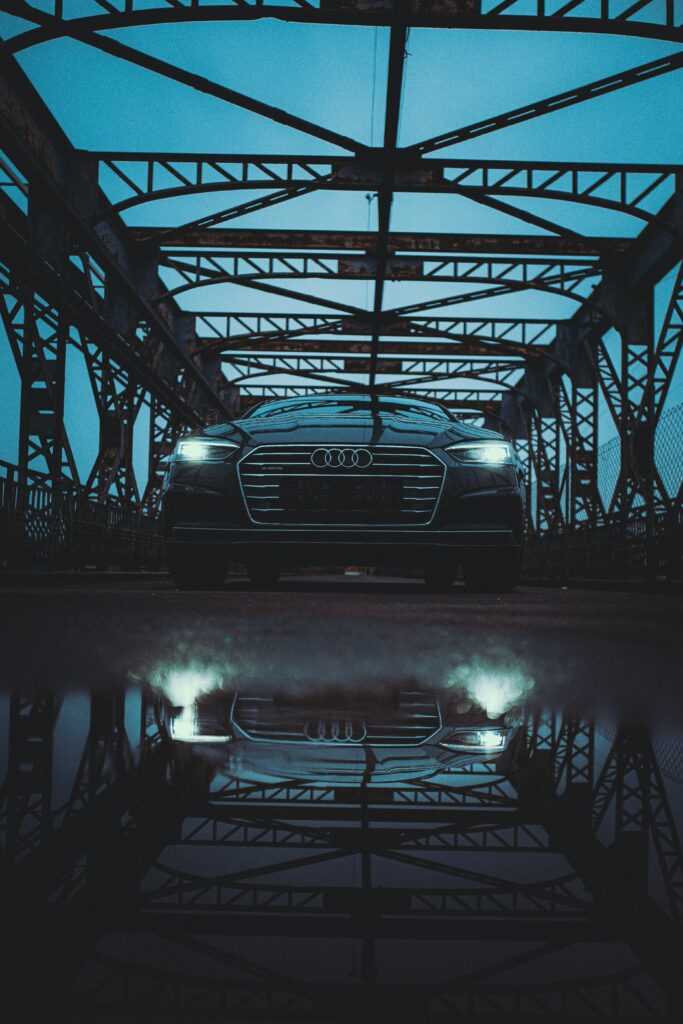 Sleek Black Audi Car on Bridge: Elegant Reflection Wallpaper