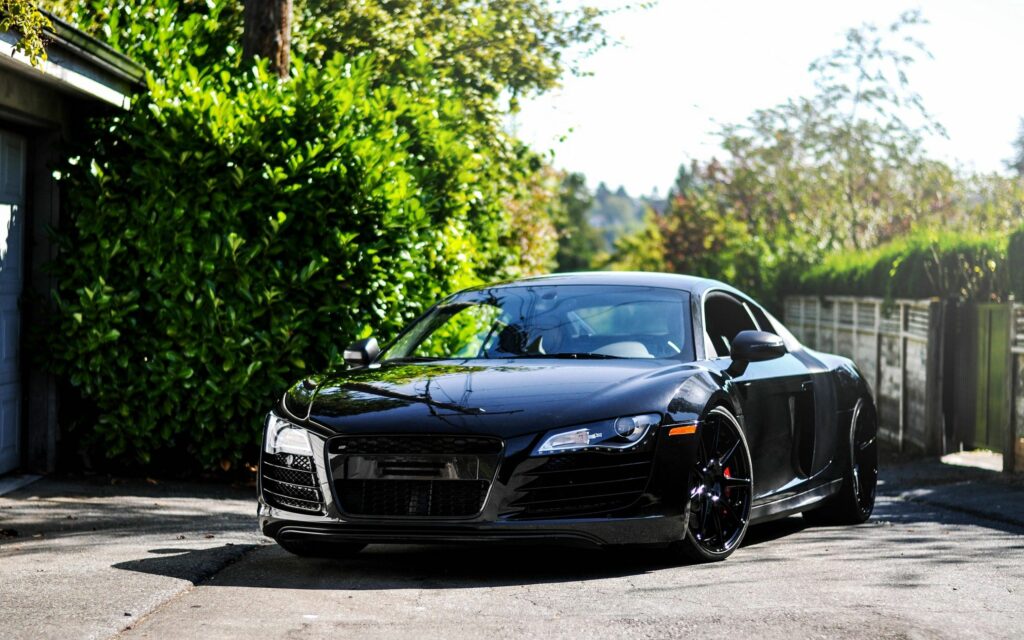 Stylish Black Audi R8 Wallpaper in Lush Green Driveway Setting