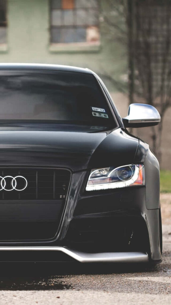 Front view of sleek black Audi RS7 with sharp headlights and reflective finish car wallpaper