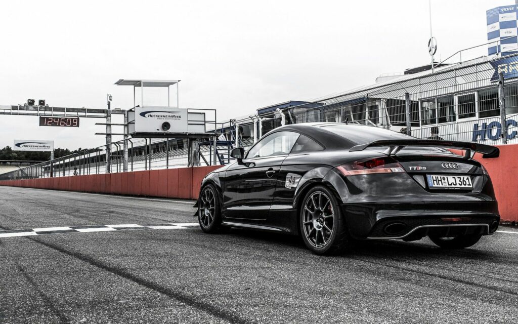 Sleek Black Audi TT RS on Racetrack - High-Performance Wallpaper